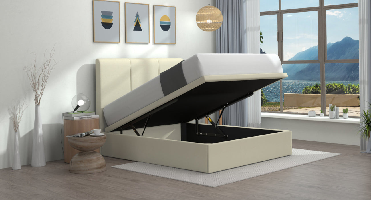 Beige upholstered bed with storage compartment in a room with large windows showing mountains.
