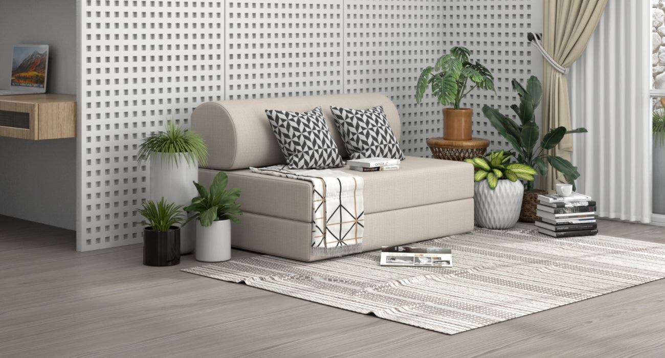 VIRO Beige classic sofa bed with cushions in a living room setting with plants and decor.